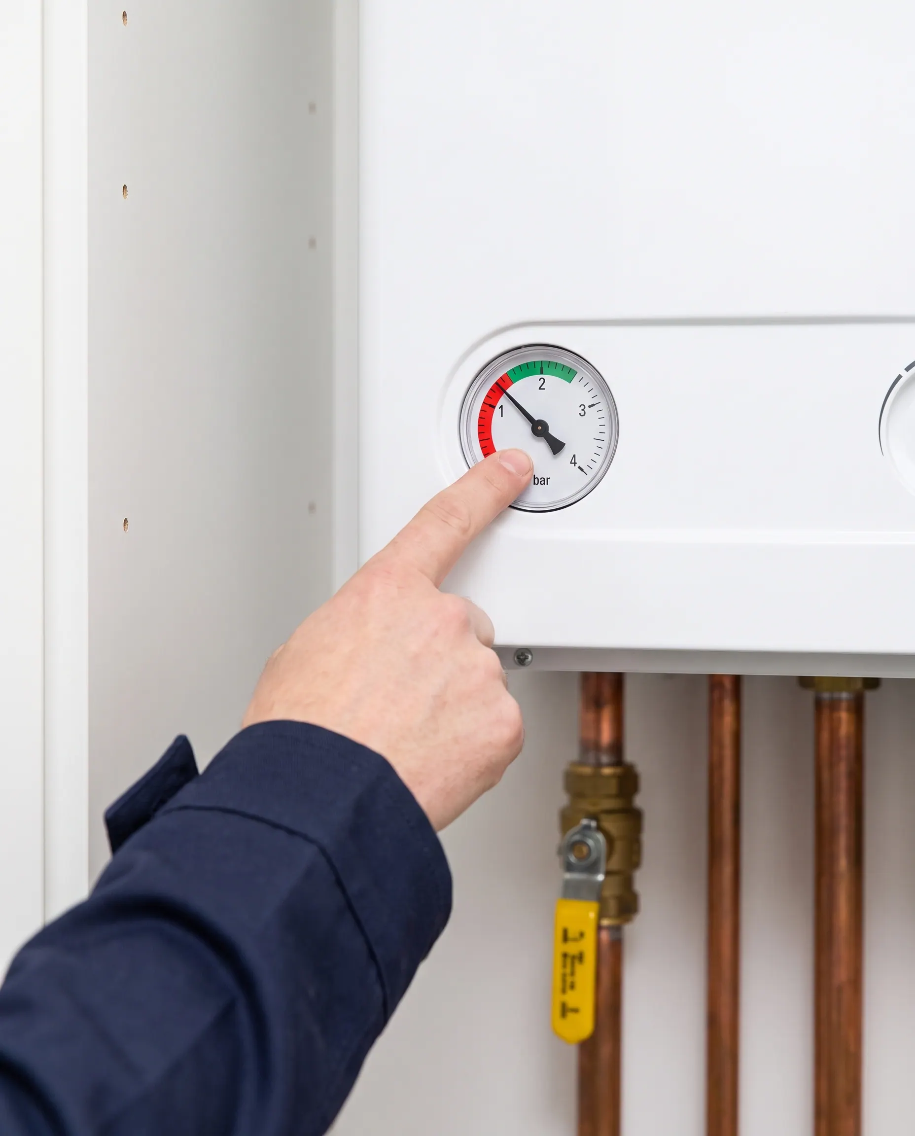 Vinger wijst naar de manometer van een cv-ketel met een waterdruk onder de 1 bar